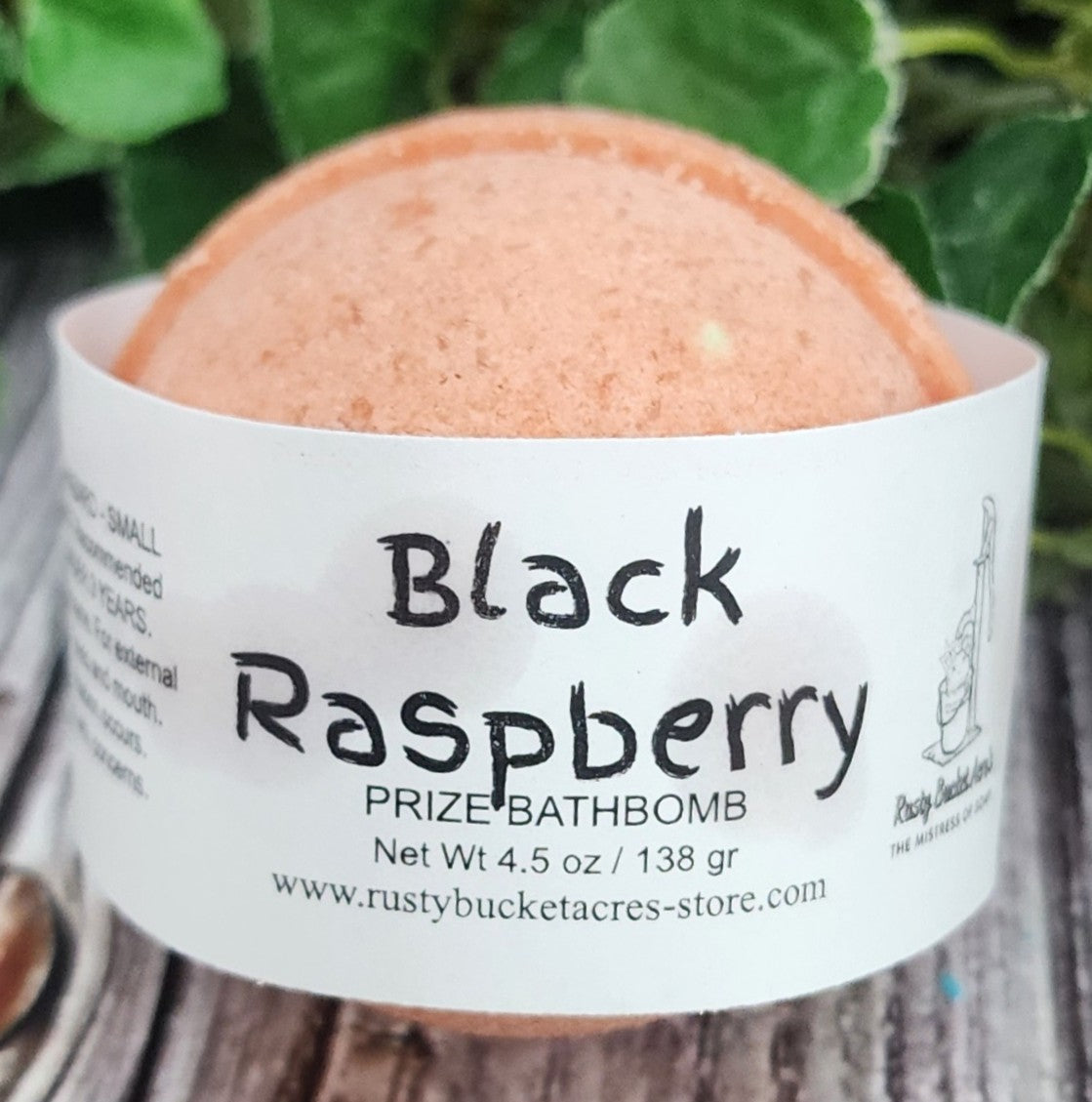 Bath bomb labeled 'Black Raspberry' with a rustic background