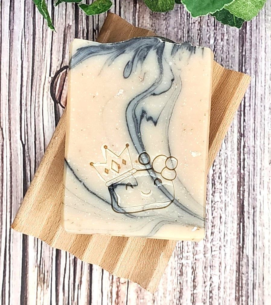 Marble-patterned soap on a wooden tray with decorative elements