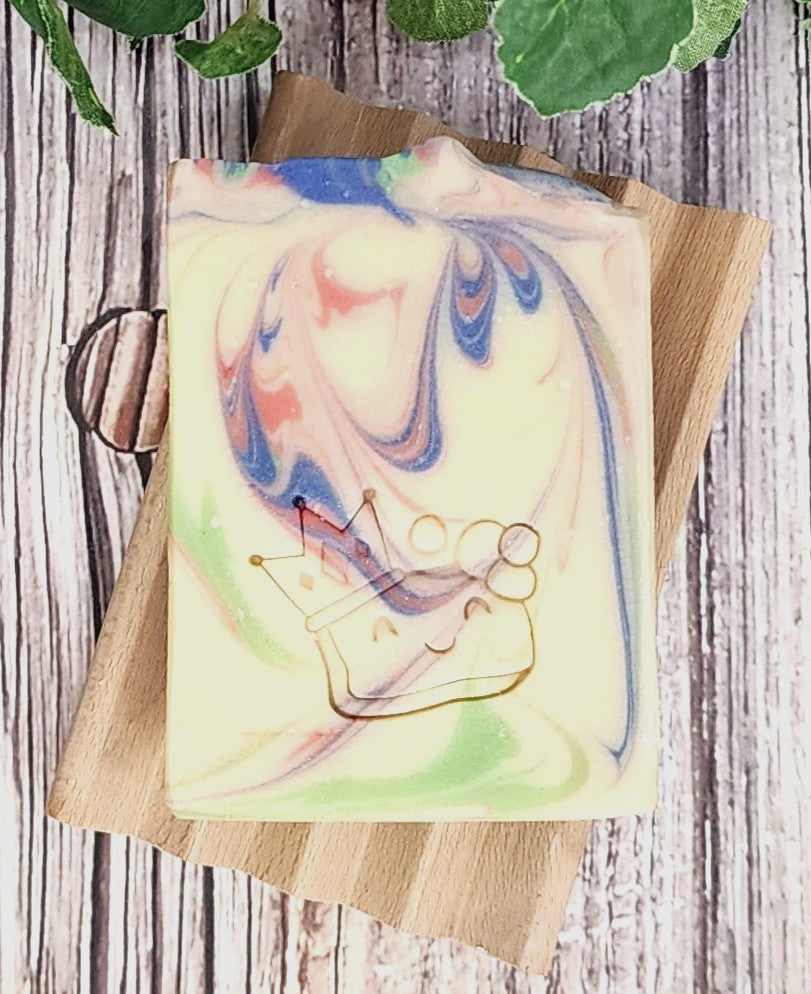 Colorful soap bar with artistic design on a wooden board