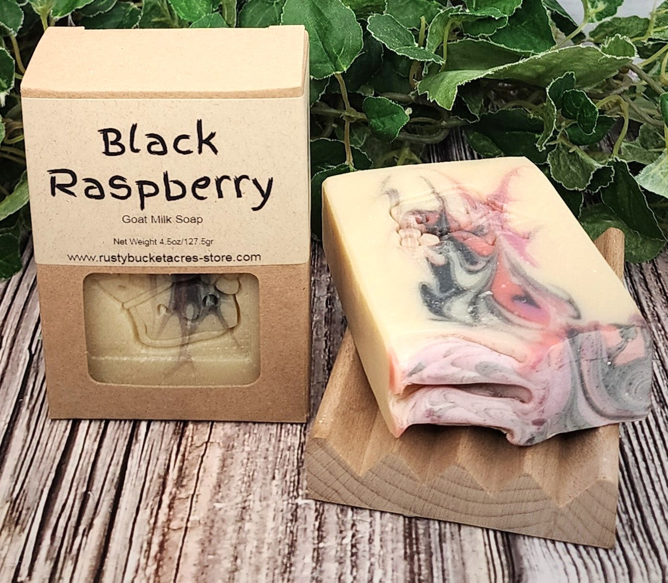 Black Raspberry soap bar with packaging on a wooden surface
