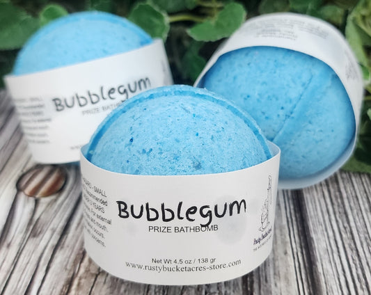 Blue bath bomb with 'Bubblegum' label on a wooden surface