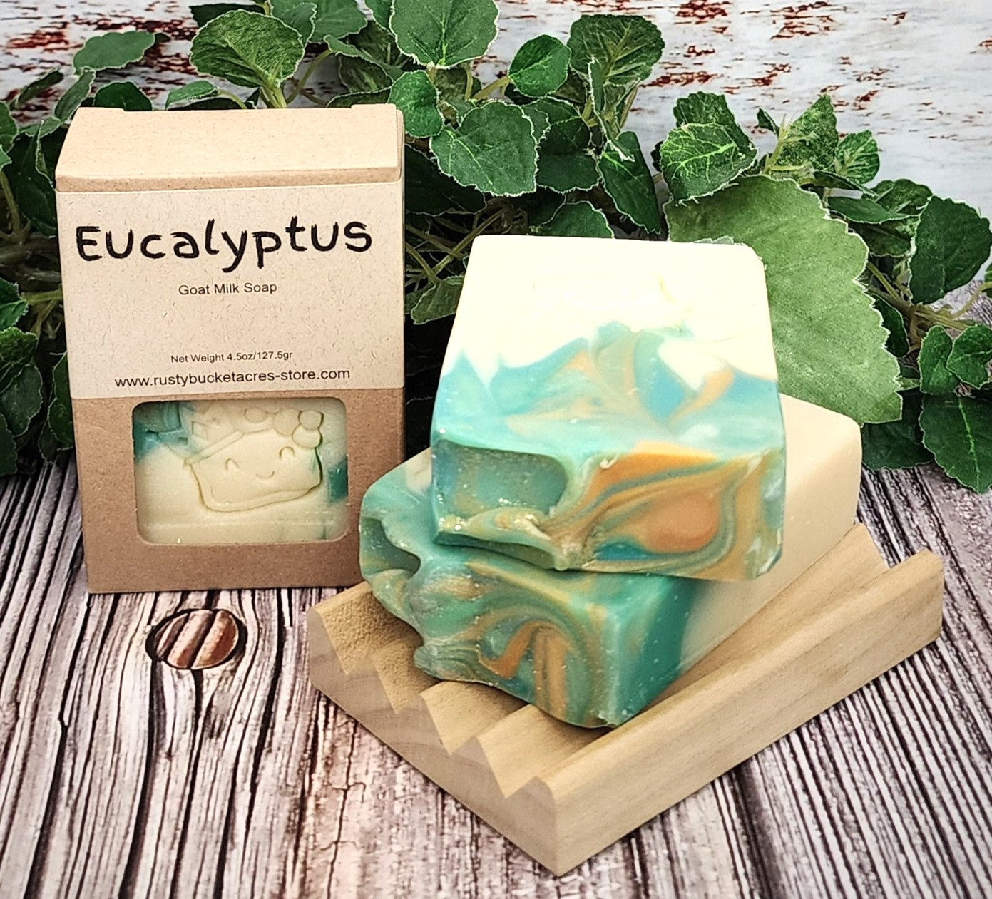 Eucalyptus soap with packaging on a wooden surface with green leaves in the background