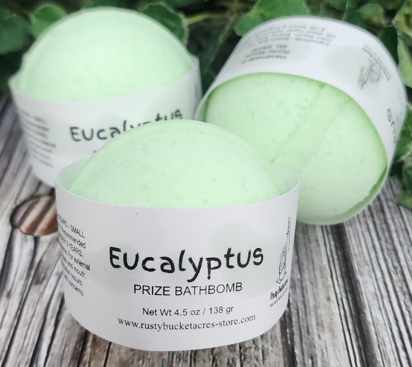 Eucalyptus bath bombs with labels on a wooden surface