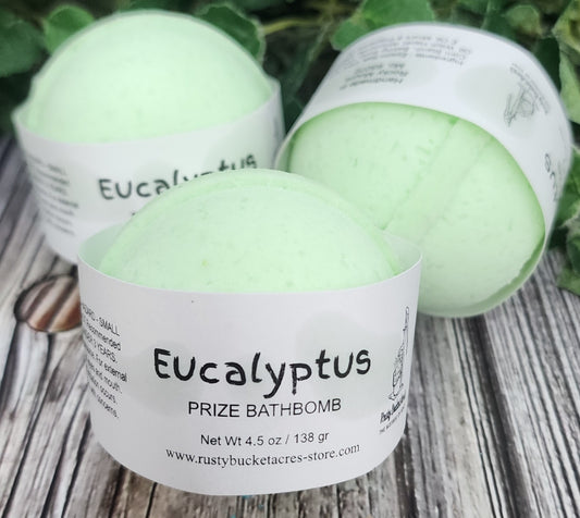 Eucalyptus bath bombs with labels on a wooden surface