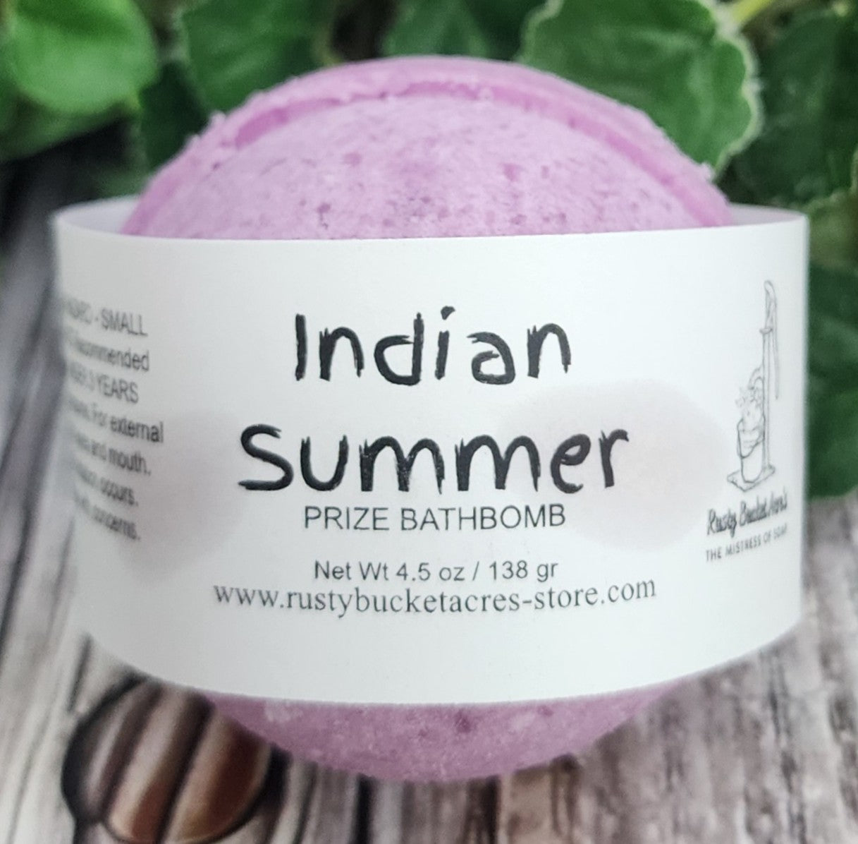 Purple bath bomb with 'Indian Summer' label on a white background