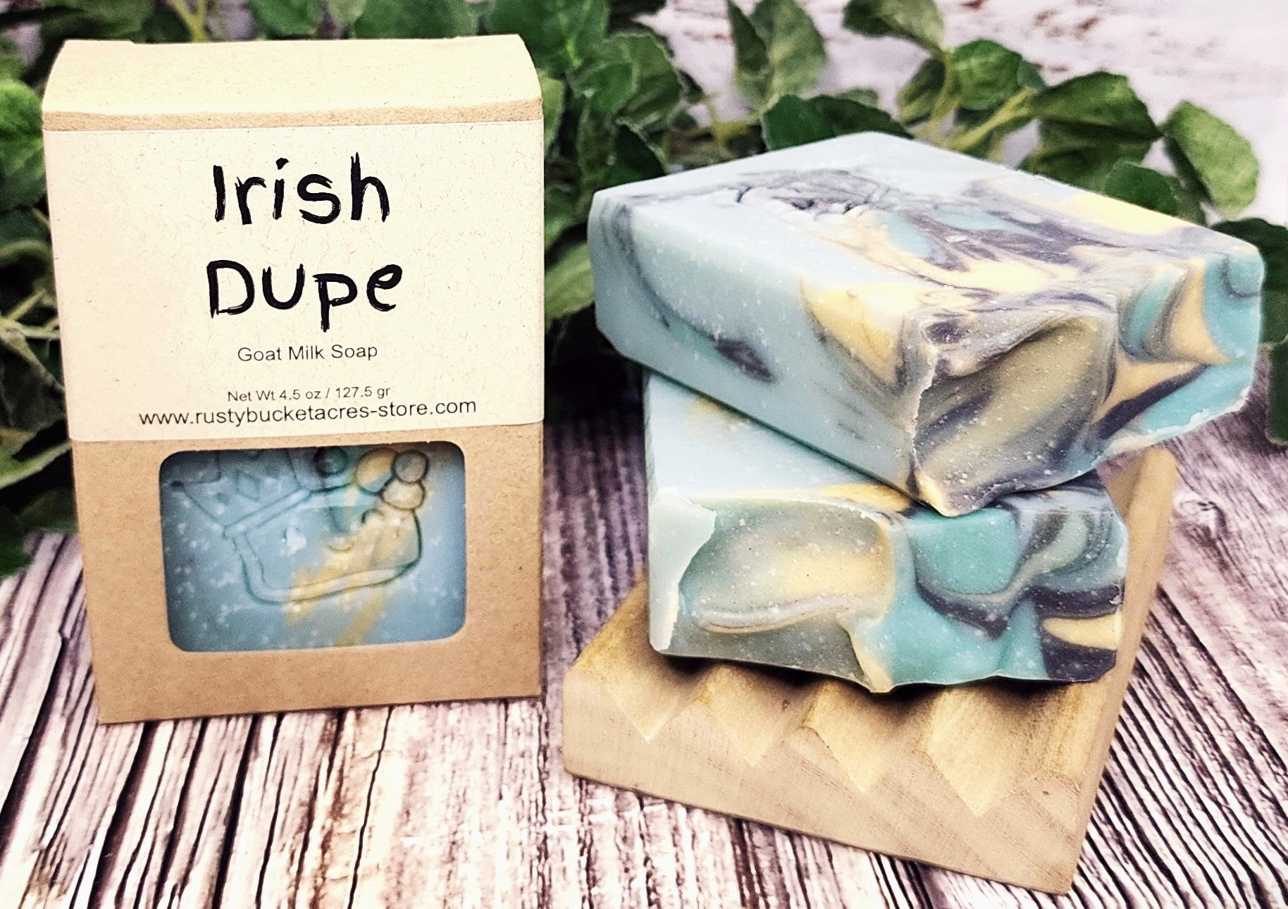 Irish Dupe goat milk soap with packaging on a wooden surface