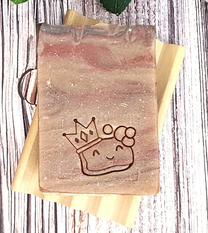 Handmade soap with a cute design on a wooden background
