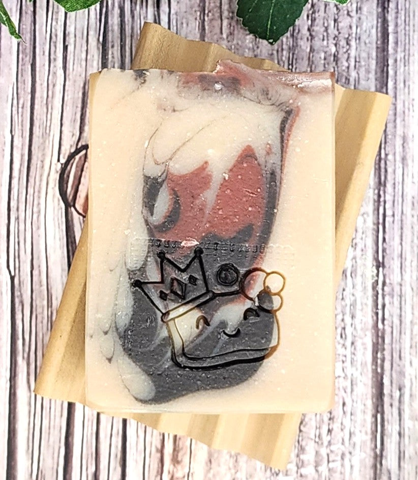 Soap with a design of a face wearing a crown on a wooden background