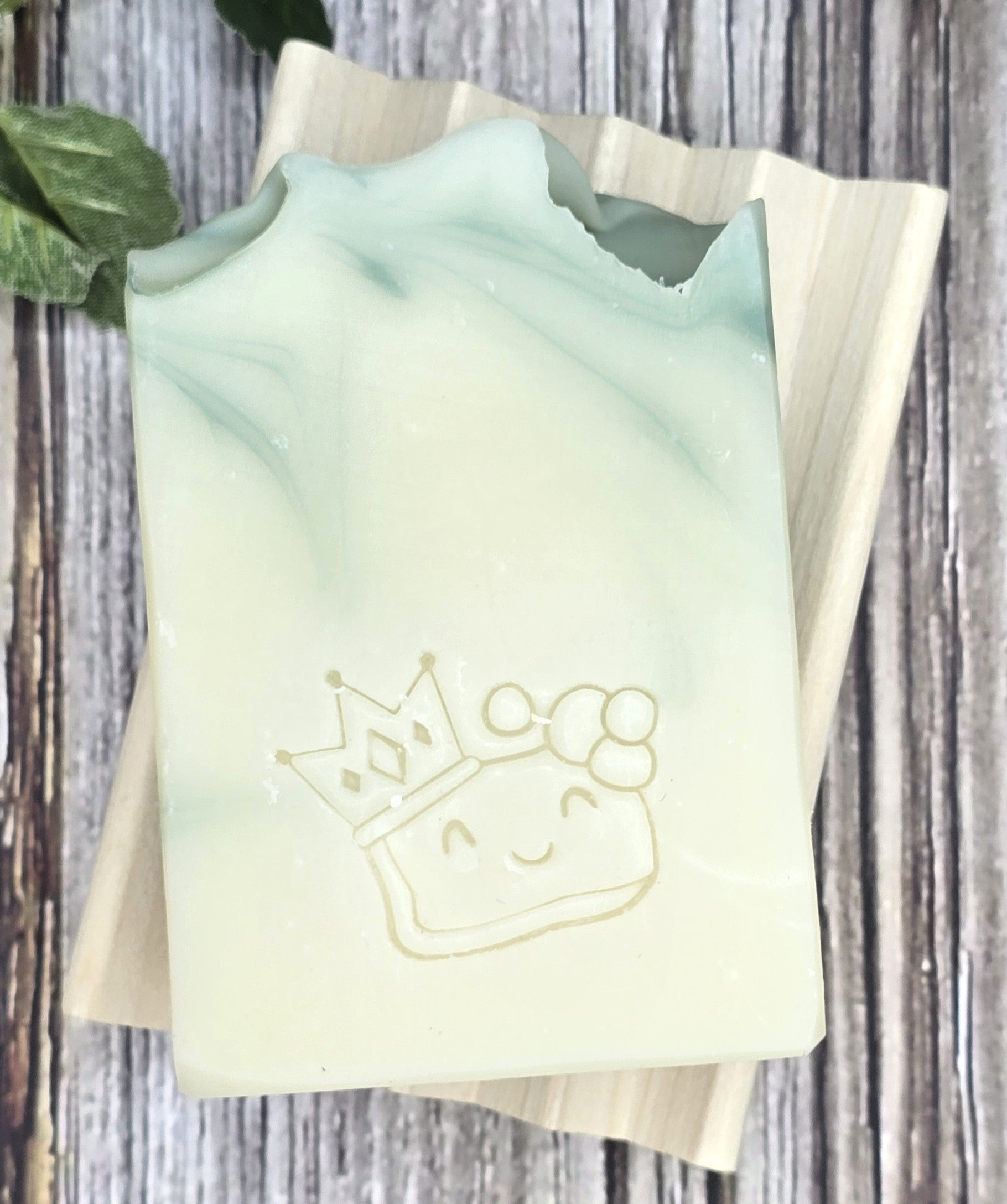 Rosemary Shampoo Bar with a princess design on a wooden surface