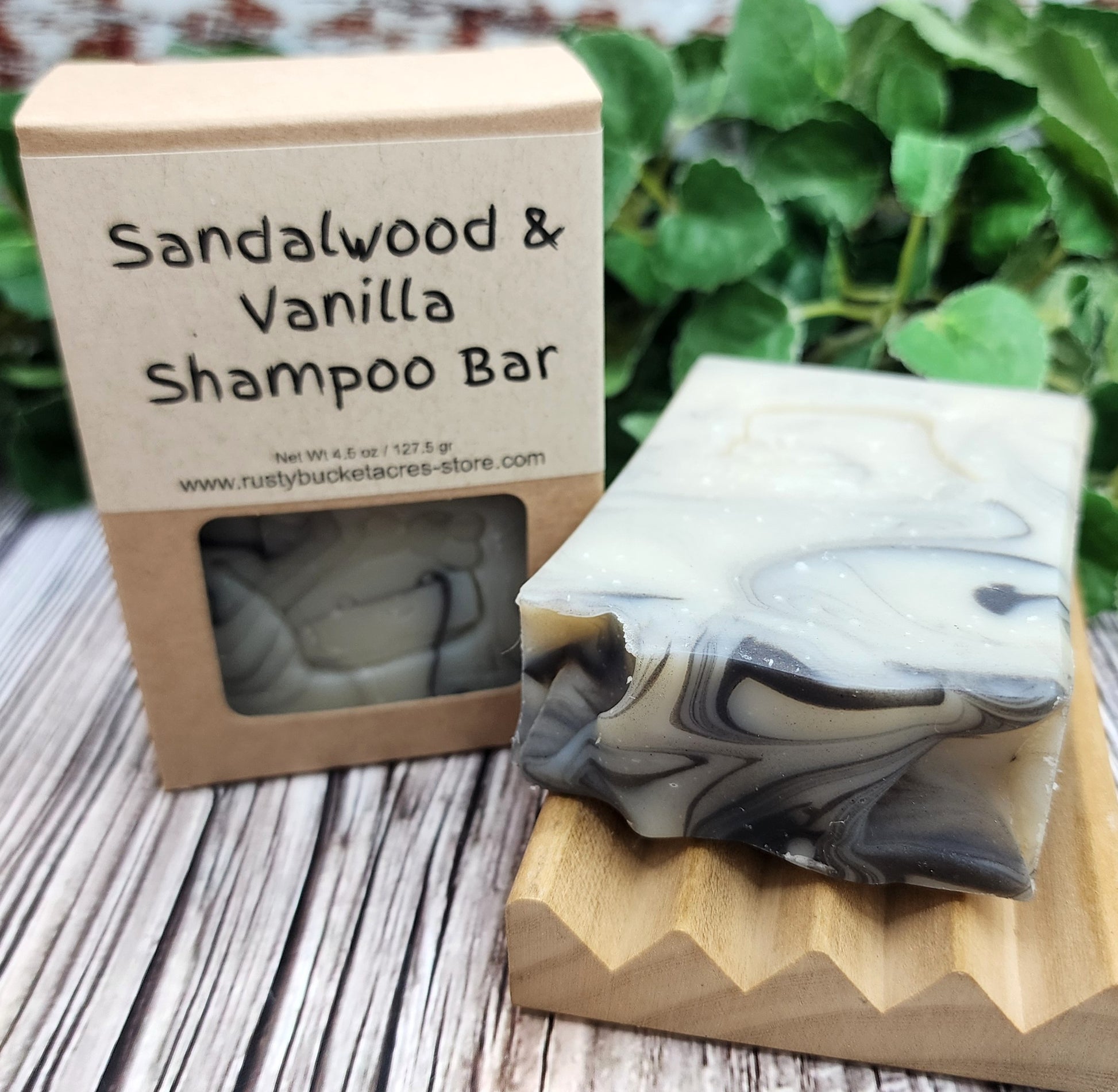 Sandalwood & Vanilla Shampoo Bar with packaging on a wooden surface