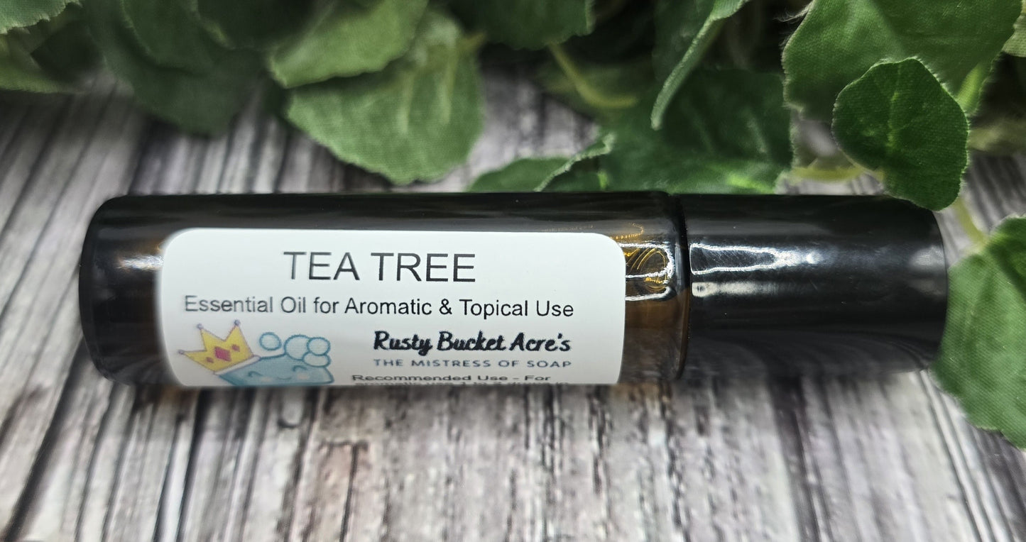 Tea tree essential oil roller bottle on a wooden surface with green leaves in the background