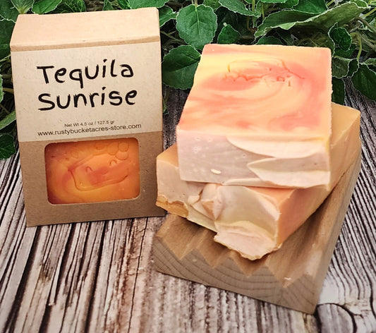 Tequila Sunrise soap bar with packaging on a wooden surface