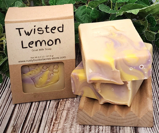 Twisted Lemon goat milk soap with packaging on a wooden surface