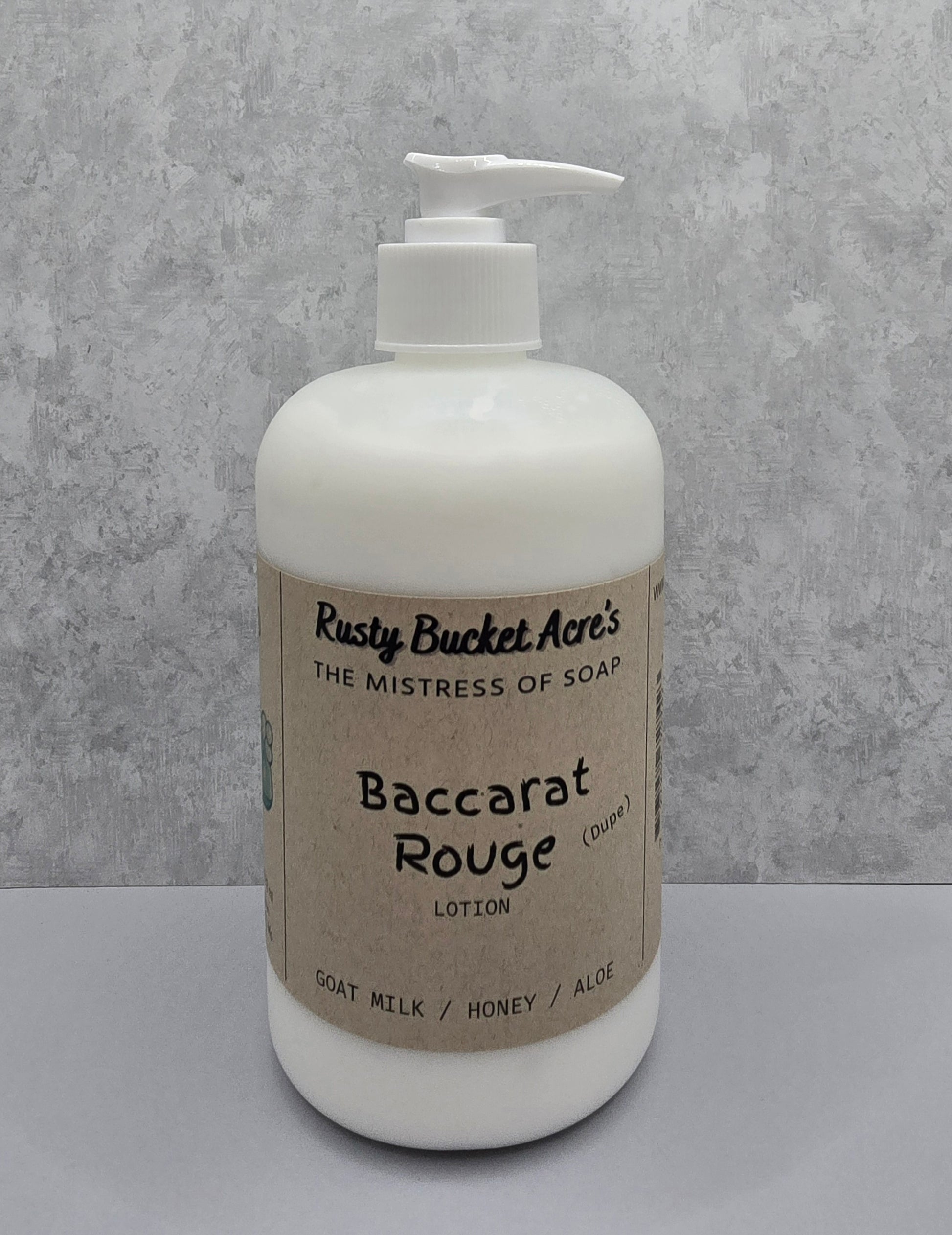 White lotion bottle with pump and 'Rusty Bucket Acres Baccarat Rouge Dupe' label on a gray background